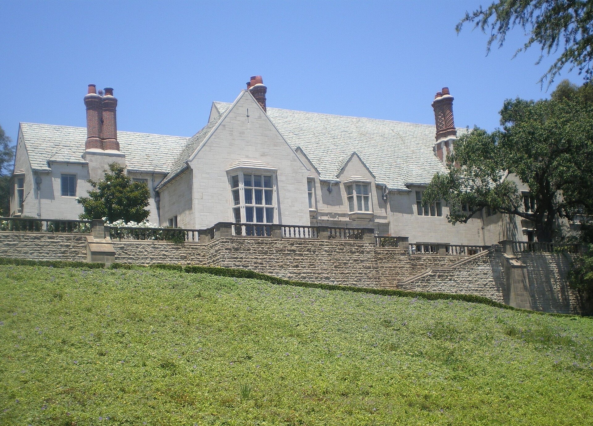 Greystone Mansion in Beverly Hills seen from its lawn under a blue sky